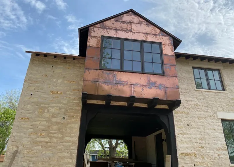Copper metal panel facade on a stone building for Skylight Installation in Denham Springs