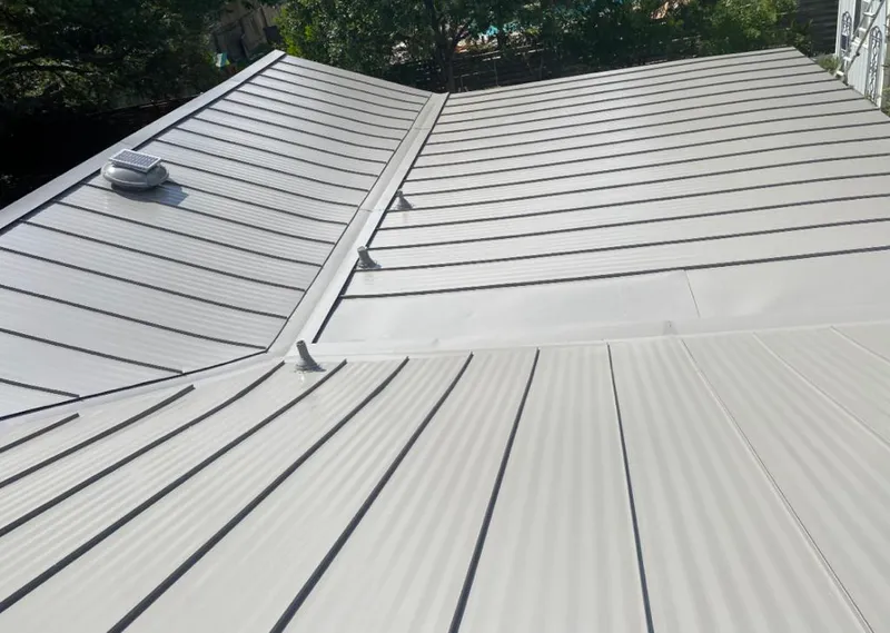 Solar attic fan installed on a metal roof for Roof Ventilation in Denham Springs